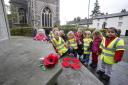 Toddlers lay hand-crafted poppy wreath at memorial