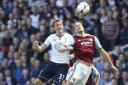 Harry Kane (left) and Andy Carroll contest an arial duel last season. Picture: Action Images