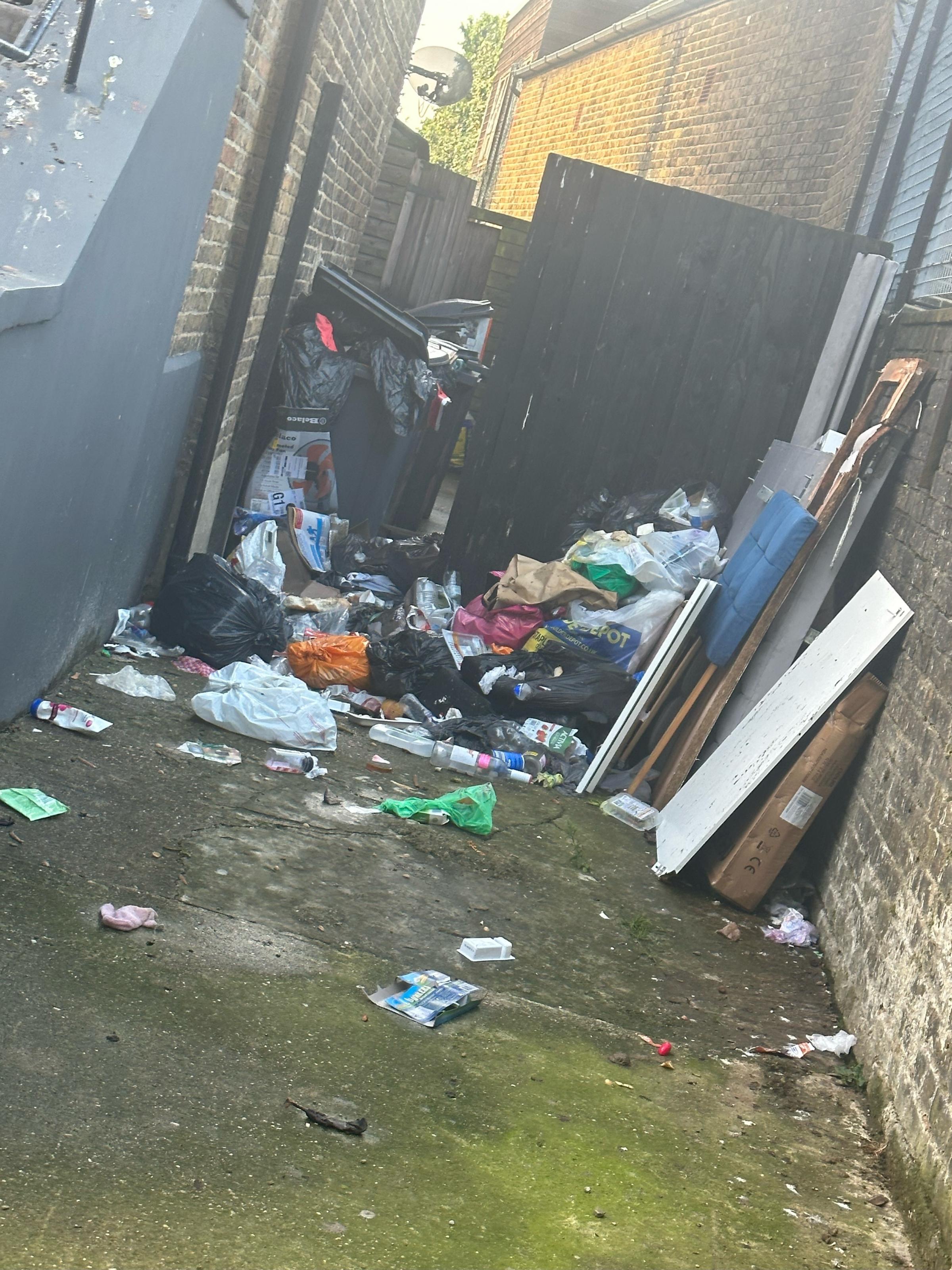 Rubbish dumped next to the flats. Photo: Denica Williams
