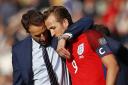 Gareth Southgate embraces Harry Kane following his last-gasp equaliser against Scotland on Saturday. Picture: Action Images