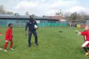 Ledley King playing football with children