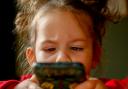 A generic picture of a child with smartphone. Tamara Bogen's children ran up a £600 bill on the iPhone Play Together game app