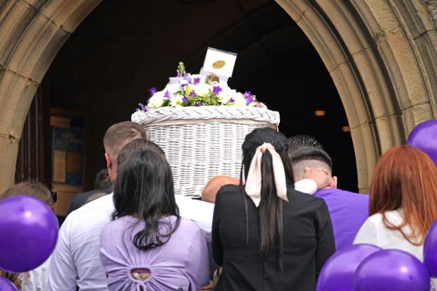 The coffin for Katie Kenyon is carried into St Leonard’s Church, Padiham, near Burnley (Peter Byrne/PA)