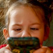 A generic picture of a child with smartphone. Tamara Bogen's children ran up a £600 bill on the iPhone Play Together game app