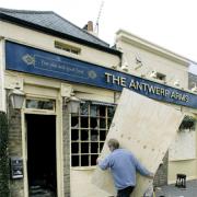 Workers spent Monday boarding up the smashed windows of the pub.
